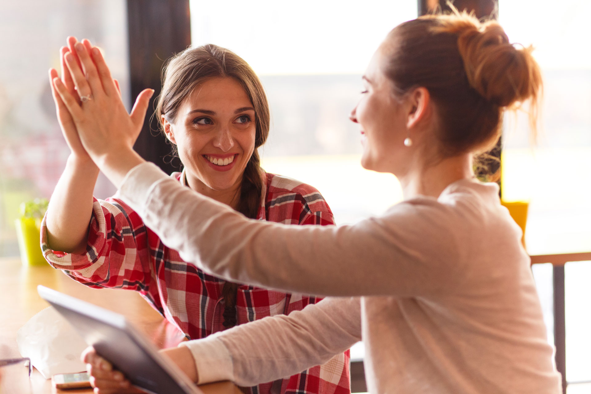 beautiful girl giving-highfive while spending time with each other