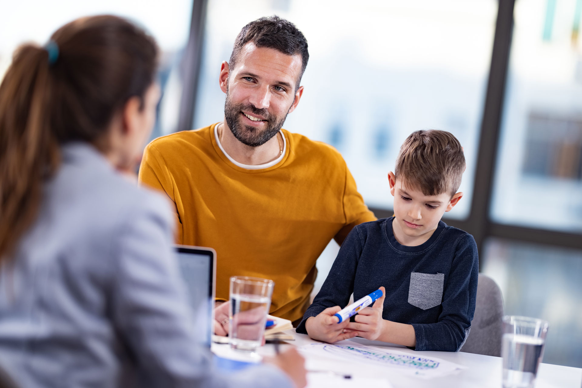a dad with her son talking with a health professional